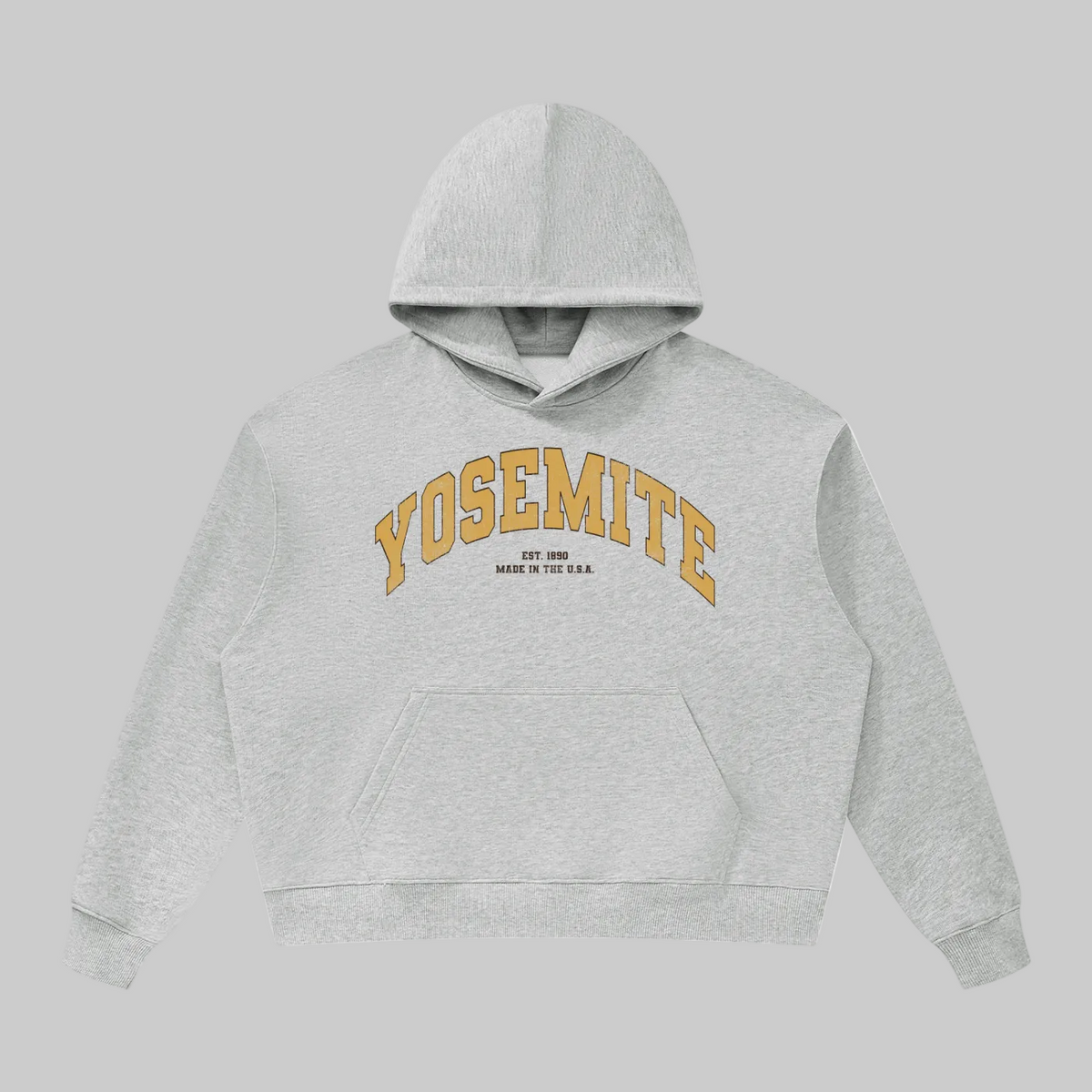 A light heather gray pullover hoodie with 'YOSEMITE' printed in an arched gold font across the chest, with smaller text underneath reading 'EST. 2009' and 'MADE IN THE U.